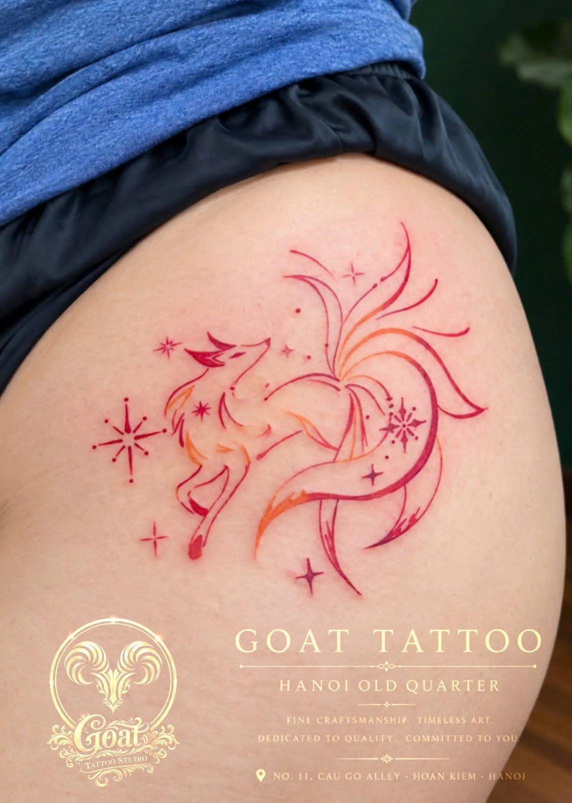 A fox in flowing gradient line art with sparkles, tattooed on the hip, by GOAT Tattoo Studio in Hanoi's Old Quarter.