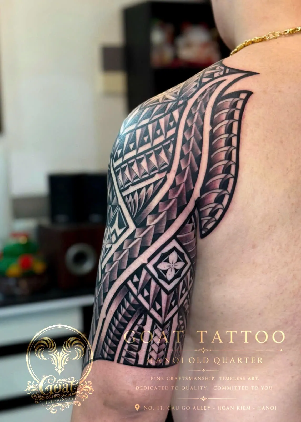 A detailed Polynesian tribal blackwork sleeve covering the shoulder and upper arm, by GOAT Tattoo Studio Hanoi.
